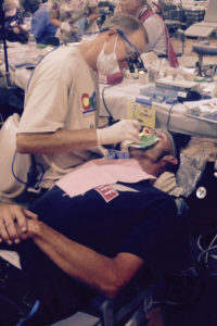Dr. Albers works on a patient at the 2015 COMOM Dental Clinic