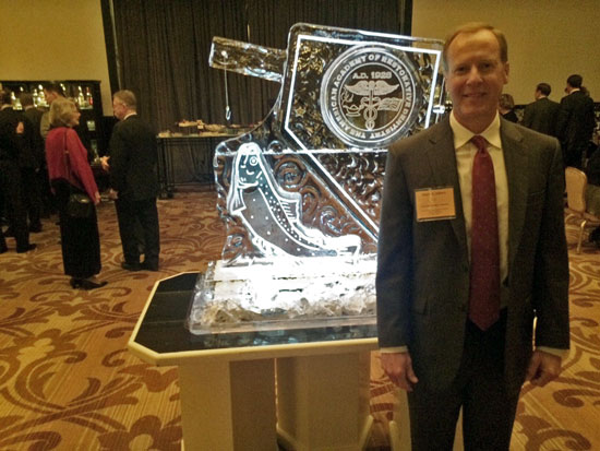 Dr. Albers standing in front of ice sculpture at the 2016 Academy of Restorative Dentistry Conference in Chicago, Illinois