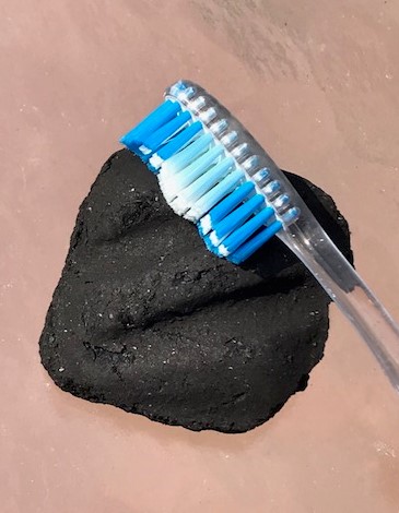 Charcoal with a toothbrush