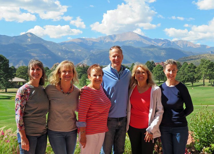 Dr. Albers and staff with Pikes Peak in backgroun