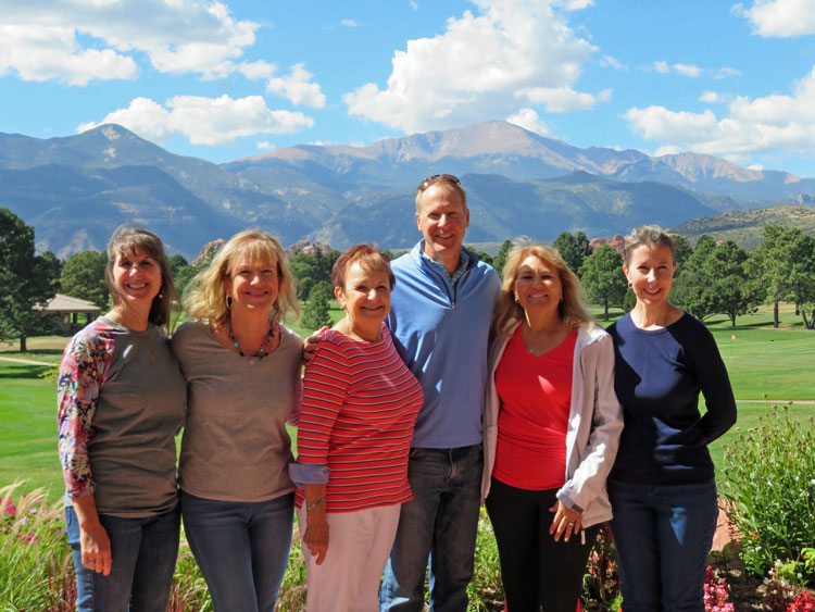 Dr. Albers and staff with Pikes Peak in backgroun